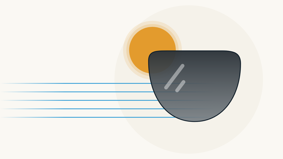 Illustration of a grey sun lens in front of an amber sun; light rays come in from the left and are dimmed by the lens.