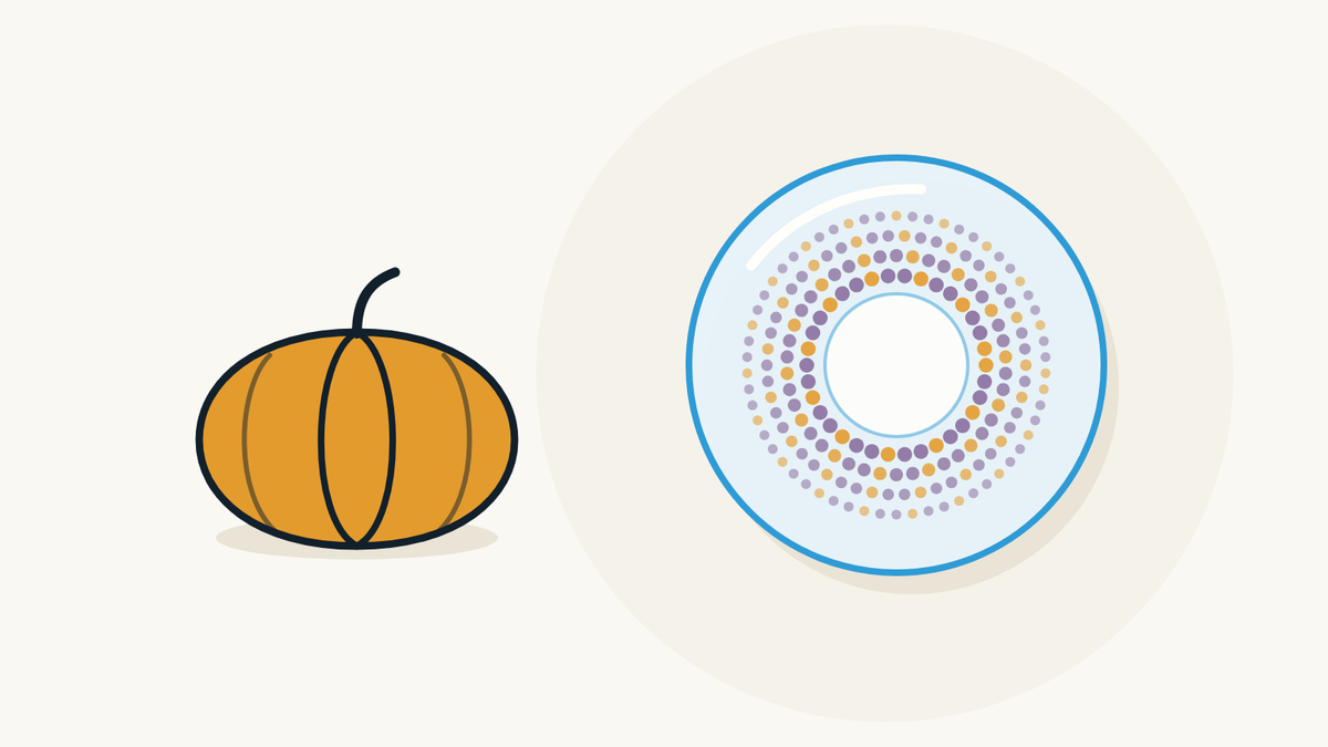 Illustration of a pumpkin next to a decorative contact lens with a coloured iris pattern.