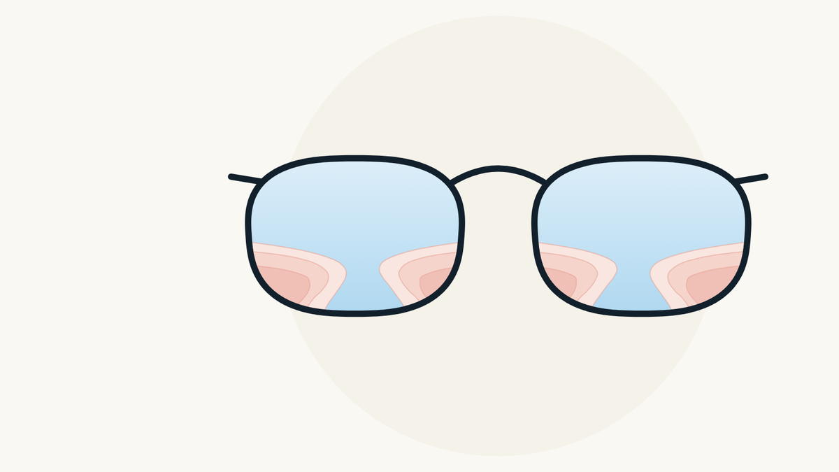 Illustration of a pair of glasses whose progressive lenses show a clear central zone and blurred zones at the lower sides.